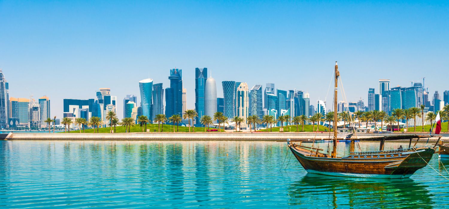Dhow in the bay of Doha overlooking the attractive skyscrapers of the business district, in Qatar