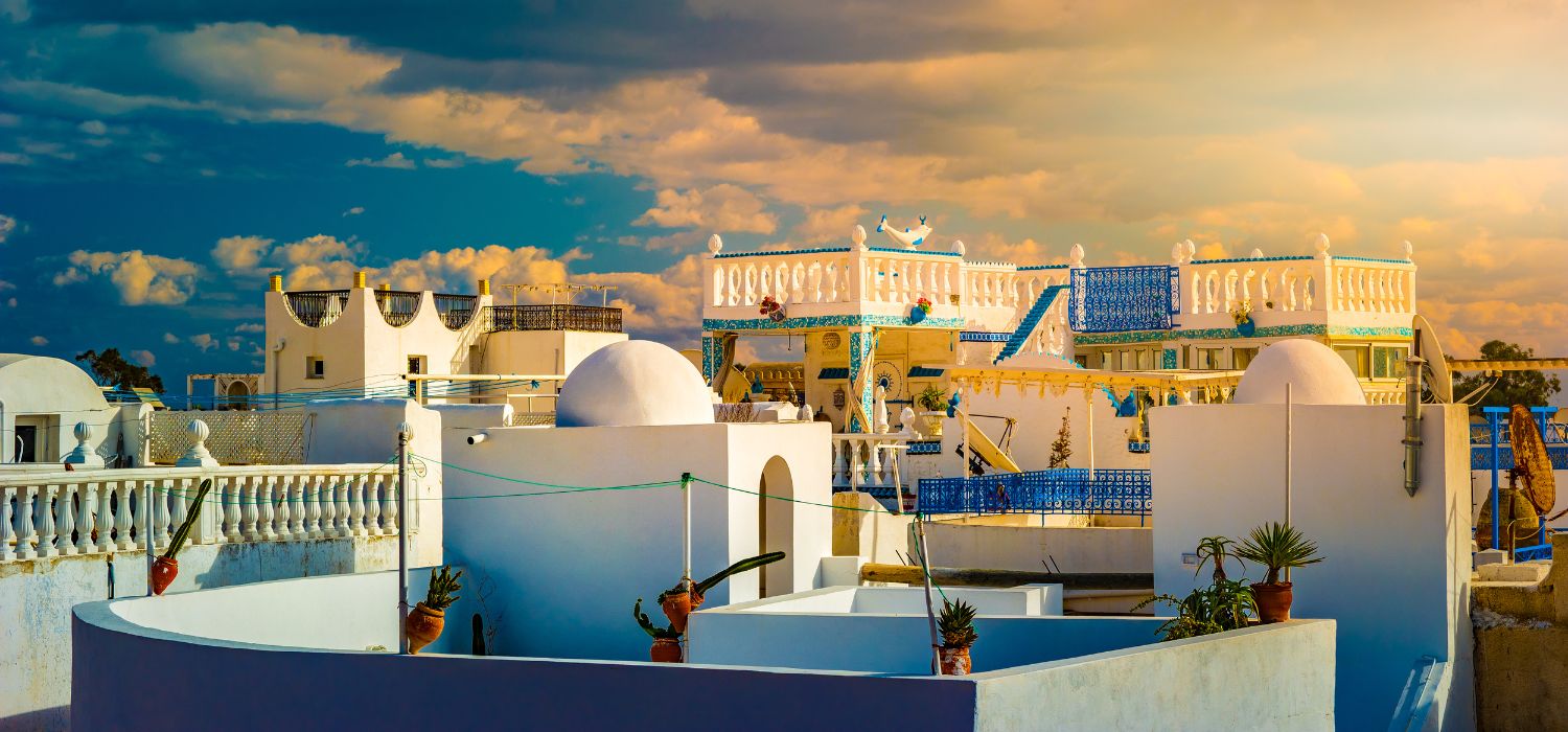 Hammamet, Tunisia. Image of architecture of old medina with dramatic sky at sunset time.